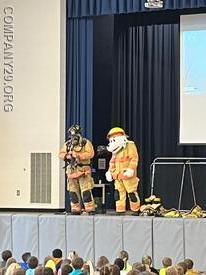 FF Nate Hudson Gears up with Sparky the Fire Dog (Deputy B.Martin) to demonstrate to the kids what it looks and sounds like when a fire fighter is fully in gear.